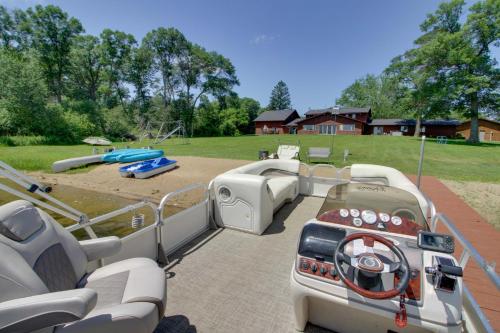 a pontoon boat parked in a yard with a playground at Lakefront Home on 17 Acres 9 Mi to Dtwn Brainerd! in East Gull Lake