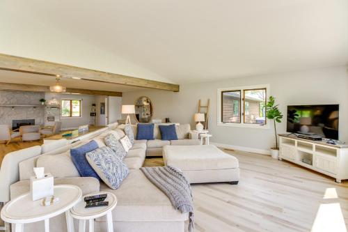 a living room with a couch and a tv at Lakefront Home on 17 Acres 9 Mi to Dtwn Brainerd! in East Gull Lake