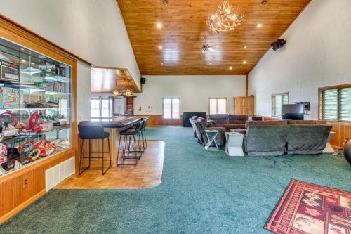 a living room with a couch and a bar at Lakefront Home on 17 Acres 9 Mi to Dtwn Brainerd! in East Gull Lake