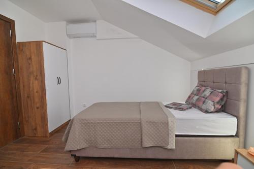 a bedroom with a bed in a white room at Lux&Spa Petko in Pirot