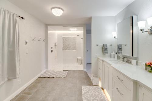 a white bathroom with a shower and a sink at Lakefront Home on 17 Acres 9 Mi to Dtwn Brainerd! in East Gull Lake