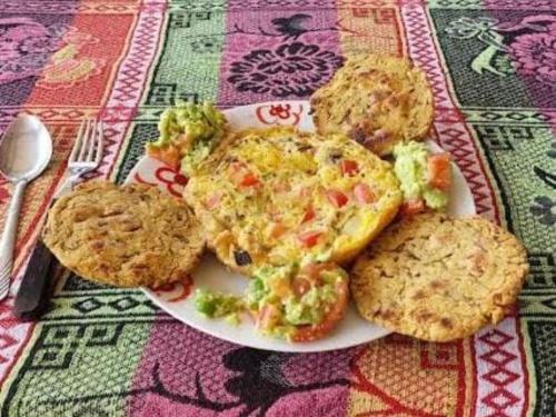 a plate of food with broccoli and cookies on a table at Hospedaje Pa'Gaïa in San Rafael