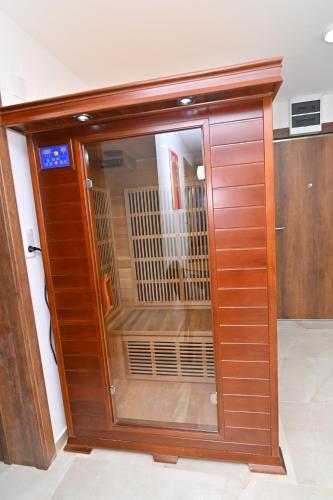 a large wooden door with a window in a room at Lux&Spa Petko in Pirot