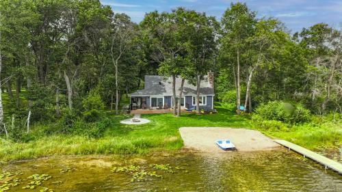 a small house in the middle of a field at Hartley Lake Hideaway - The Perfect Getaway! in Brainerd