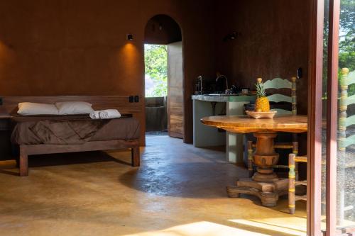 a bedroom with a bed and a table in a room at Casa Iteri in Lo de Marcos