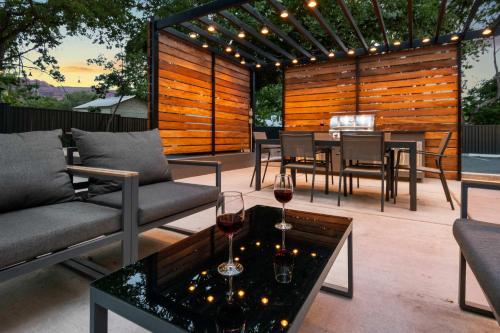 a patio with a table with wine glasses on it at Near Downtown Stylish 2BR With Amazing Patio - #2 in Moab