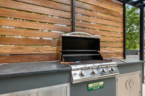 a grill on a outdoor kitchen with a wooden wall at Near Downtown Stylish 2BR With Amazing Patio - #2 in Moab