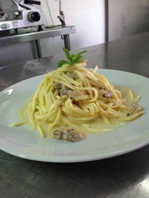 a white plate of pasta on a table at Sea Garden Hotel in Acquappesa