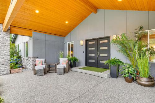 a patio with chairs and a door with plants at Amazing Outdoor Space! Everett Escape with Hot Tub in Murphys Corner