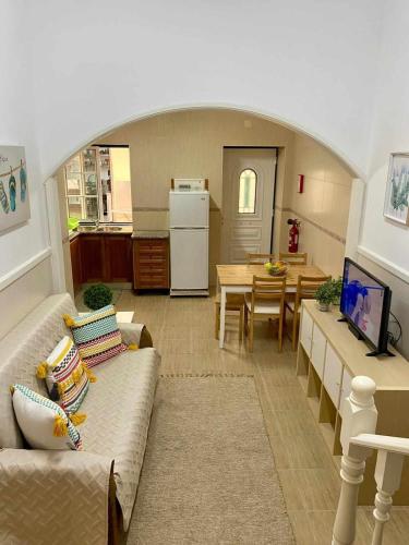 a living room with a couch and a table at Typical Nazaré House in Nazaré