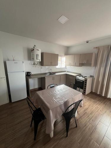 a kitchen with a table and chairs and a refrigerator at Departamento Balcarce in San Martín