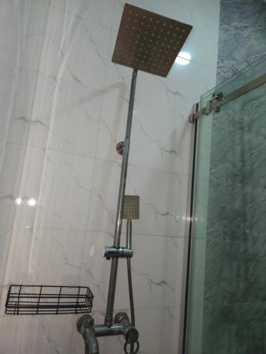 a shower with a light in a bathroom at Eko Luxury Apartments in Ikeja