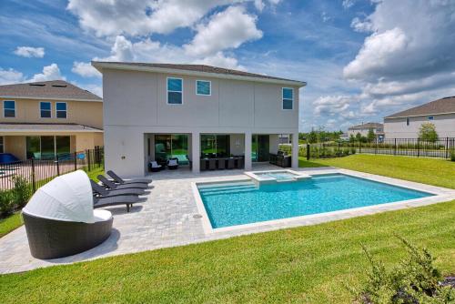 a backyard with a swimming pool and a house at Gorgeous Home With Private Pool, Themed Rooms Near Disney With Waterpark & Resort Access At Encore Resort - 7687Ff in Kissimmee