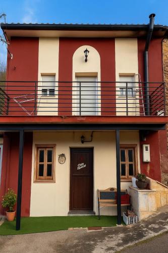 a red and white house with a balcony at Casa Milu in Armiello