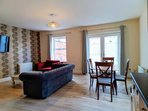 a living room with a couch and a table at City Centre C Apartment, Parking, Ground Floor in Belfast