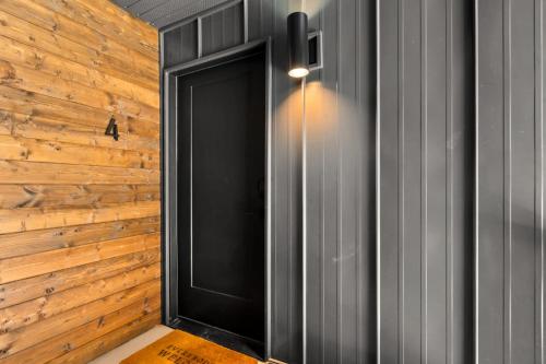 a hallway with a black door and a wooden wall at Near Downtown Stylish 2BR With Amazing Patio - 4 in Moab