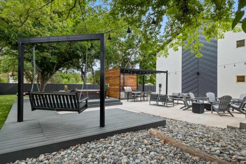 a swinging bench on a deck in a yard at Near Downtown Stylish 2BR With Amazing Patio - 4 in Moab