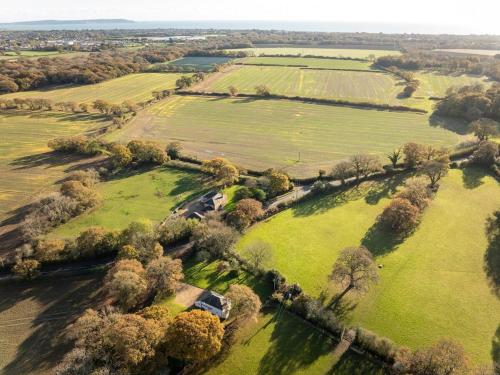 an aerial view of a field with trees and grass at Hobbs Cottage in Hinton