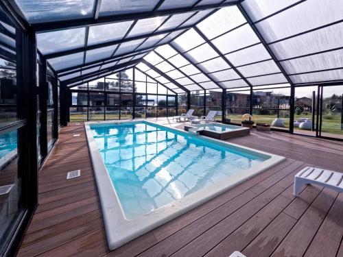 a large swimming pool with a glass roof at Luna Llena Dina Huapi in Dina Huapi