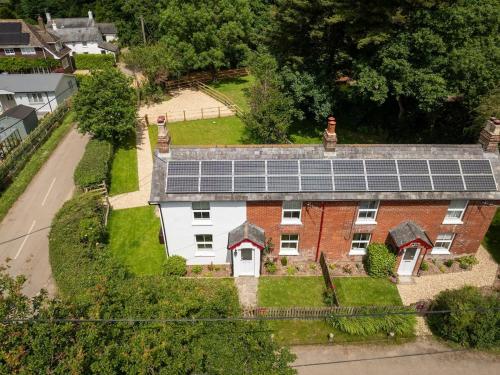 an aerial view of a house with solar panels on it at Rose cottage in Bransgore