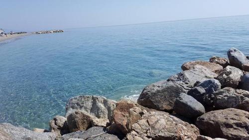 a group of rocks on the shore of a beach at Sea Garden Hotel in Acquappesa
