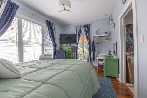 a bedroom with a large bed and a desk at The Margaret Suite at The Abbey House a B&B in Daytona Beach in Daytona Beach