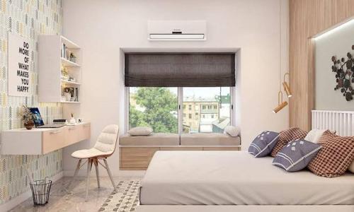 a bedroom with a bed and a desk and a window at Jataadhara Home Stays in Srikalahasti