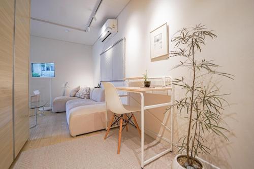 a living room with a table and a couch at Villa de EL 1 in Busan