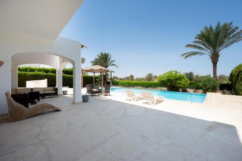 a villa with a swimming pool and a patio at VESTA - El Gouna Residence in Hurghada