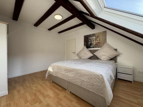a bedroom with a bed with a painting on the wall at Ramoni Apartments in Hochwiese