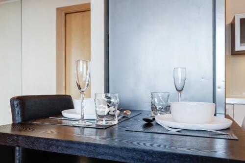 a dining room table with glasses and a table cloth at Fahle building, skyline view 1 bedroom Flat near Centre in Tallinn