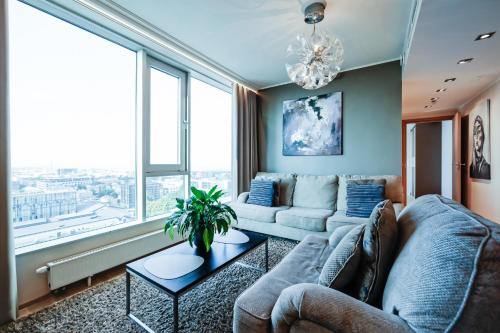 a living room with a couch and a table at Fahle building, skyline view 1 bedroom Flat near Centre in Tallinn