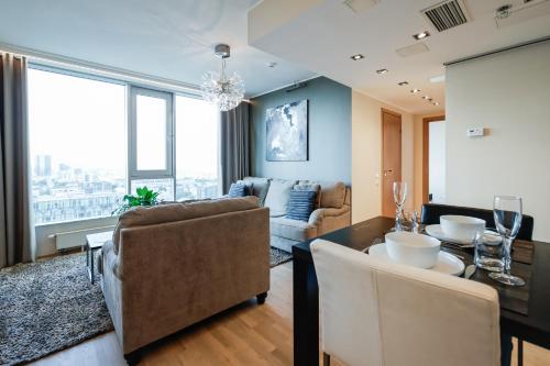 a living room with a dining table and a couch at Fahle building, skyline view 1 bedroom Flat near Centre in Tallinn
