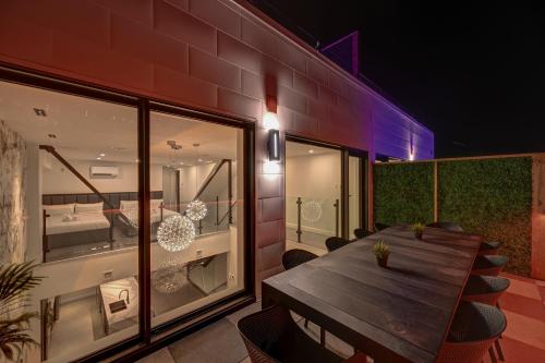 a wooden table and chairs on a balcony at night at CLUBHAUS Hotel in Montréal