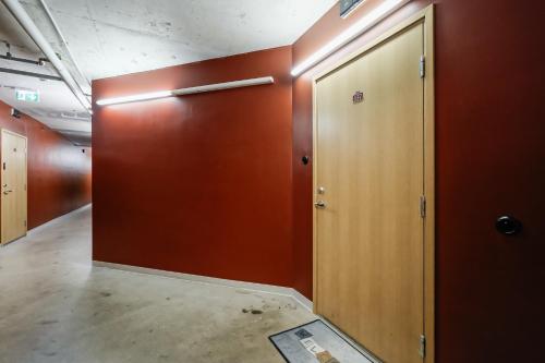 an empty corridor with a wooden door in a room at Fahle building, skyline view 1 bedroom Flat near Centre in Tallinn