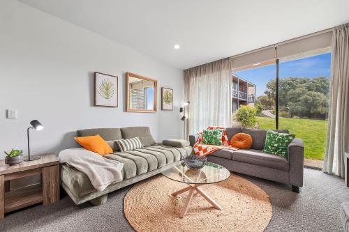 a living room with a couch and a table at 1BR Apartment 43 sleeps 5,Golf,Beach,Hot Springs in Fingal