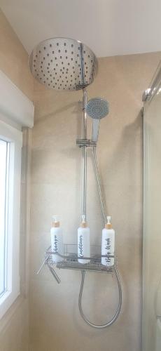 a shelf in a bathroom with two candles on it at Habitación privada Jardín in Tafalla