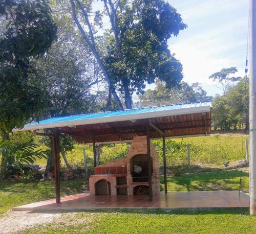 a shelter with a brick oven in a park at Sikeo Eco Glamping in Icononzo