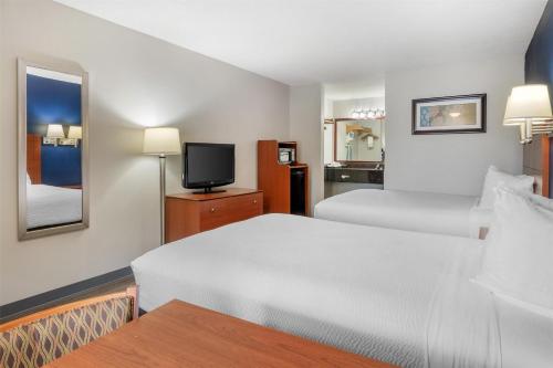 a hotel room with two beds and a tv at Best Western Acworth Inn in Acworth
