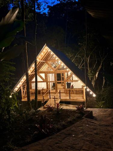 a cabin in the woods at night at Sikeo Eco Glamping in Icononzo