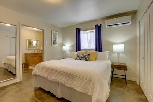 a bedroom with a large bed and a window at Oro Valley Guest House with Roof Top Views in Oro Valley
