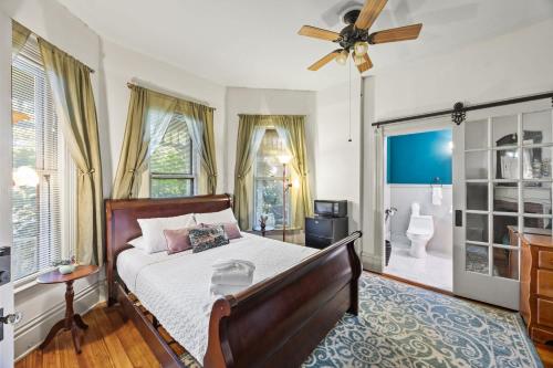 a bedroom with a bed and a ceiling fan at Spacious Historic House Near Louisville Sites in Louisville