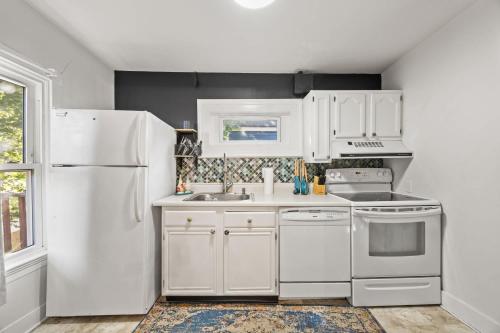 a kitchen with white appliances and a white refrigerator at Spacious Historic House Near Louisville Sites in Louisville