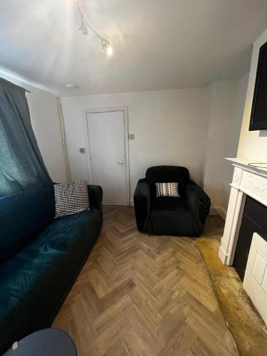 a living room with a couch and a chair at close to stadium and the beach 2 bed groundfloor,sky Netflix in Grimsby