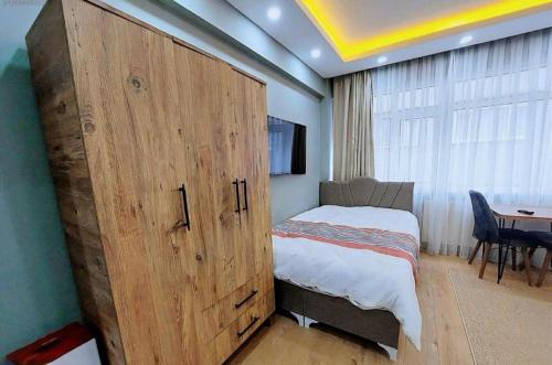 a bedroom with a large wooden door with a bed and a table at Sleepy Taksim Hotel in Istanbul