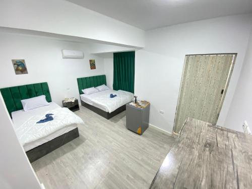 a hotel room with two beds and a mirror at Retaj Pyramids View in Cairo