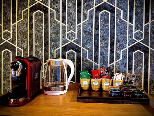 a counter with a blender and other items on a table at Loft Apartments in Duhok