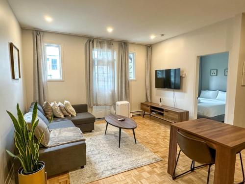 a living room with a couch and a table at Lovely One-Bedroom in Vibrant Plateau Mont-Royal in Montréal