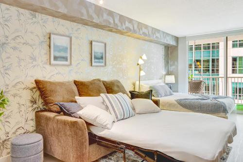 a living room with a couch and a bed at The Bay Suites - Brickell in Miami