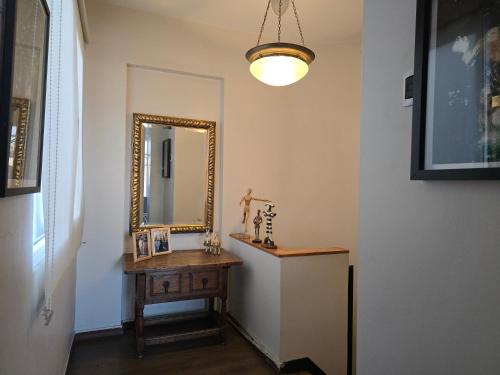 a bathroom with a mirror and a wooden table at Santiago Centro Bellas Artes Lastarria in Santiago